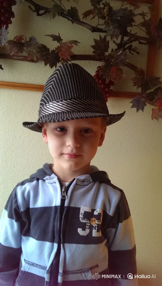 Young Boy Removes Hat, Reveals Hair in Gentle Smile – AI Generated Video | Hailuo AI