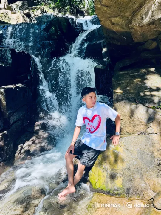 Young Man Contemplates Nature at Waterfall – AI Generated Video | Hailuo AI