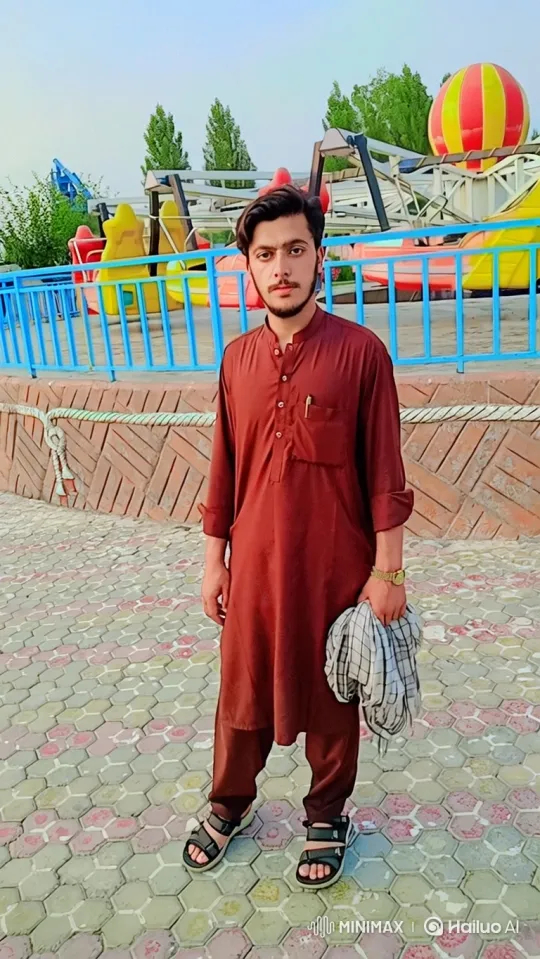Young Man on Patio Observes Amusement Park in Tracking Shot – AI Generated Video | Hailuo AI
