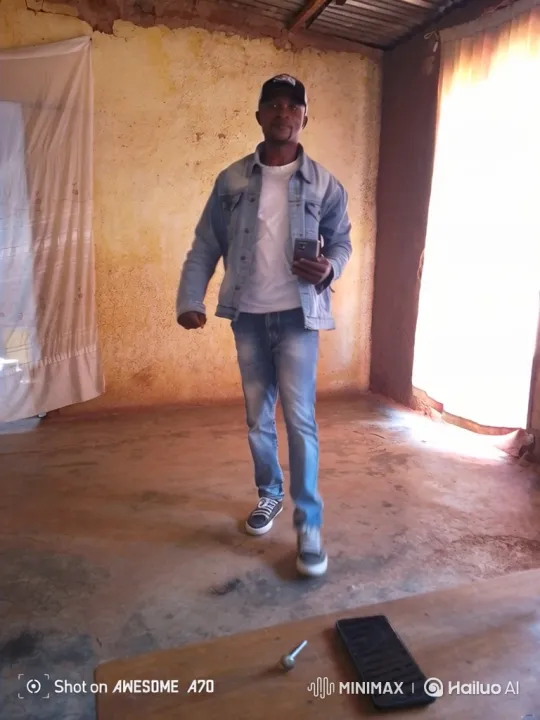Man in Denim Jacket Stands in Sunlit Room – AI Generated Video | Hailuo AI