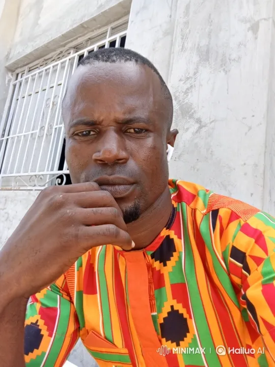 Man in Contemplative Pose with Striped Shirt – AI Generated Video | Hailuo AI