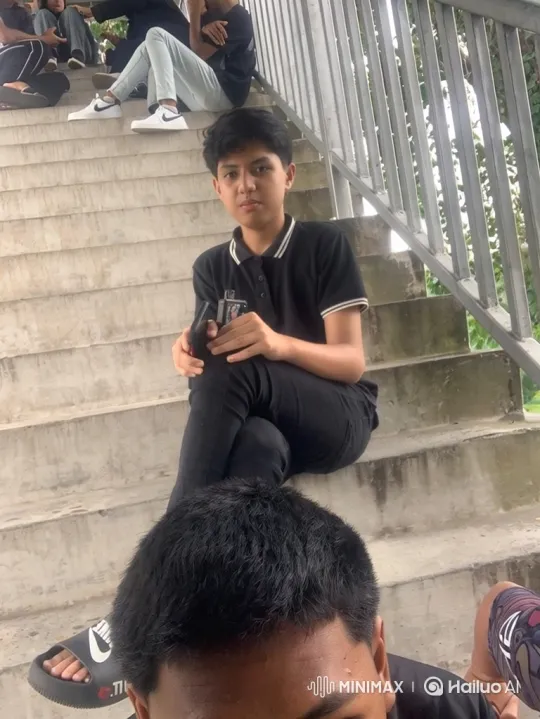 Young Man on Stairs with Candid Zoom-Out Scene – AI Generated Video | Hailuo AI