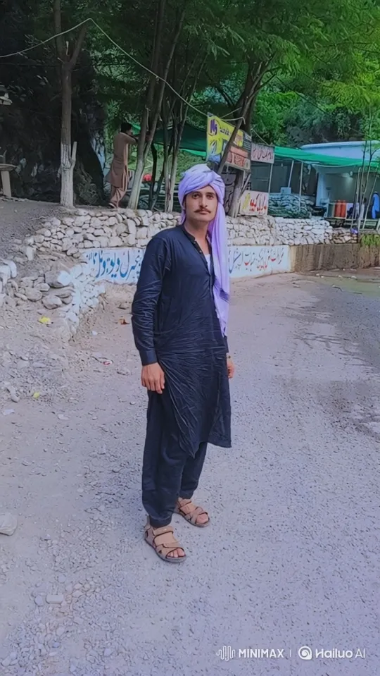 Man in Black Attire Smiles Gently on Gravel Road – AI Generated Video | Hailuo AI