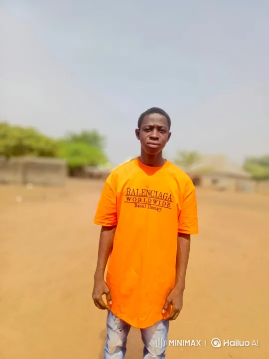 Young Man in Orange Shirt in Dusty Landscape – AI Generated Video | Hailuo AI