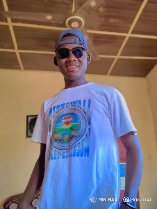 Young Man in Graphic T-Shirt Smiles at Camera – AI Generated Video | Hailuo AI