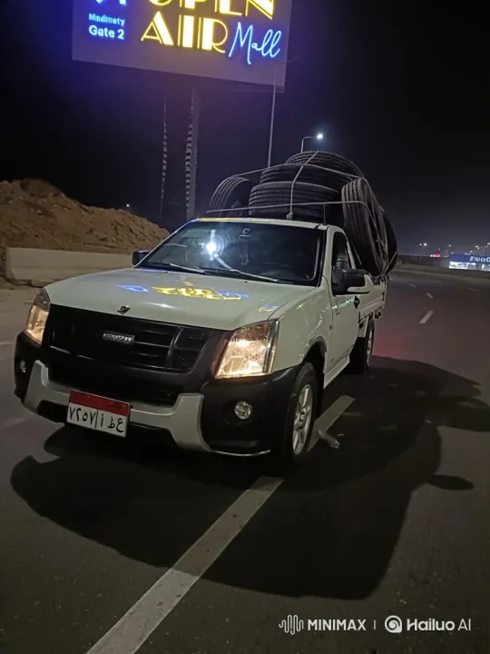 Night Drive of a Pickup with Tires Past Open Air Mall Sign – AI Generated Video | Hailuo AI