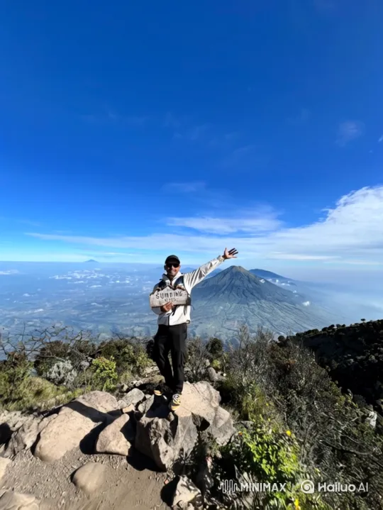 Victorious Man on Mount Sumbing: A Journey from Peak to Valley Floor – AI Generated Video | Hailuo AI