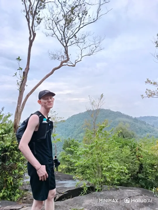 Young Hiker Admires Mountain View in Slow Zoom-Out – AI Generated Video | Hailuo AI