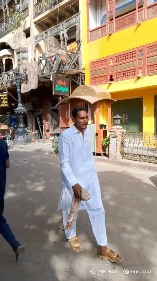 Man Walks Down Sunlit Street Holding Snake – AI Generated Video | Hailuo AI