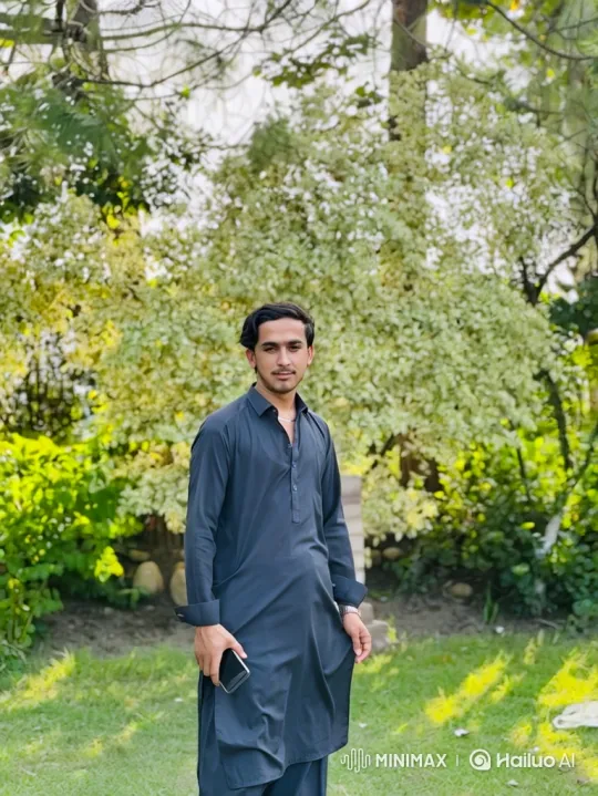 Young Man on Lawn with Gentle Breeze and Calm Expression – AI Generated Video | Hailuo AI