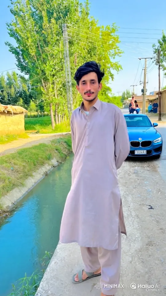 Young Man by Water with Expansive Rural Background – AI Generated Video | Hailuo AI