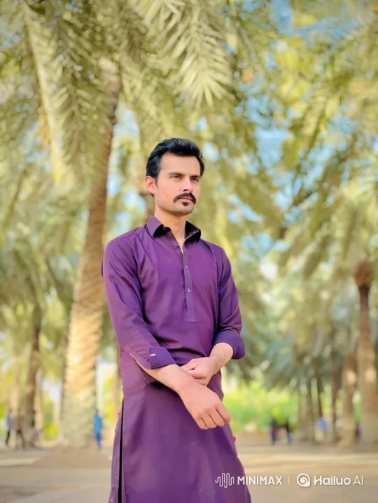 Thoughtful Man in Palm Grove Amidst Gentle Breeze – AI Generated Video | Hailuo AI