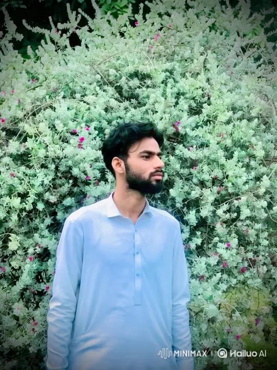 Young Man in Blue Tunic Amidst Swaying Bushes – AI Generated Video | Hailuo AI