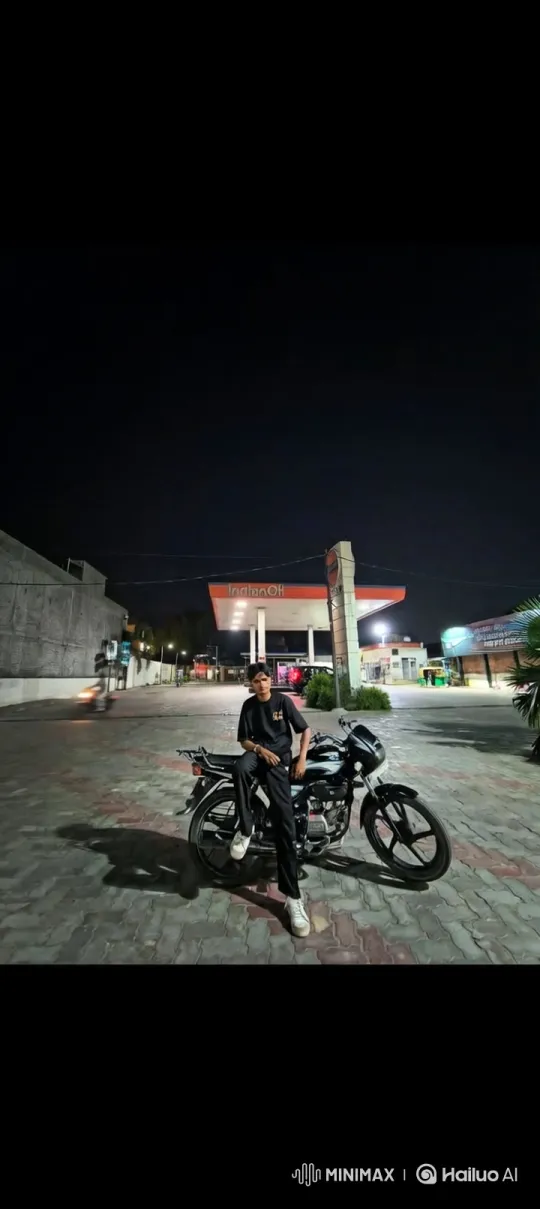 Steady Vertical Rise Reveals Motorcycle, Man, and Nighttime Gas Station – AI Generated Video | Hailuo AI