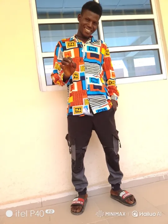 Young Man in Colorful Outfit Smiles at Camera – AI Generated Video | Hailuo AI