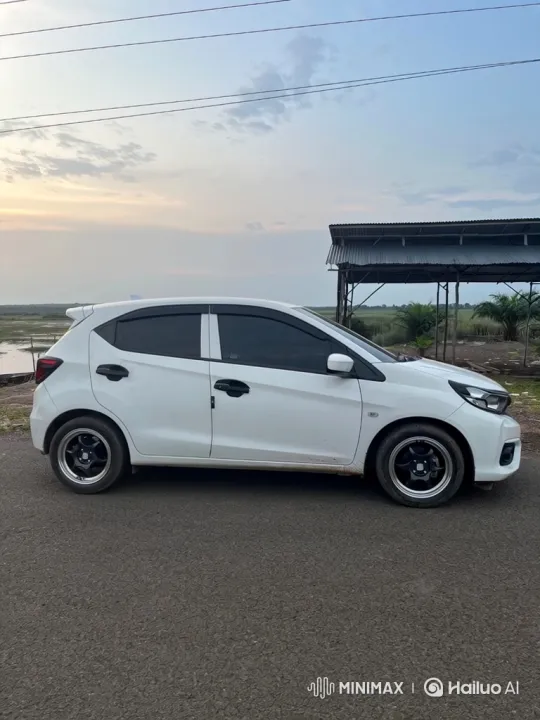 White Hatchback Lowering Its Suspension on Asphalt – AI Generated Video | Hailuo AI