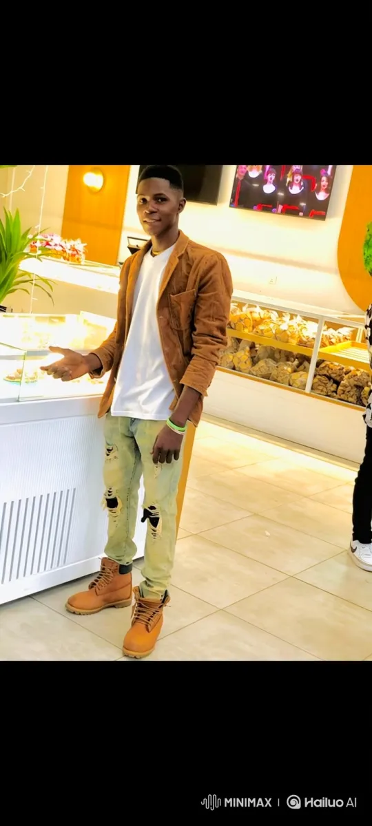 Young Man in Bakery: Friendly Greeting with Soft Focus Background – AI Generated Video | Hailuo AI