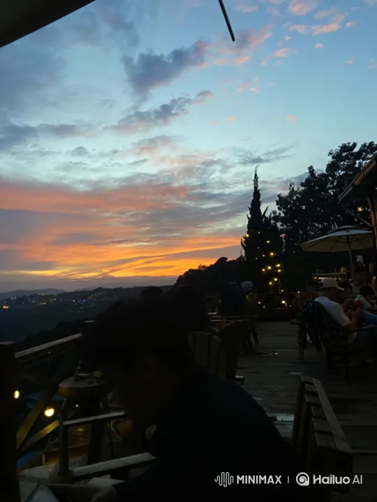 Tranquil Sunset at Hillside Cafe with City Lights – AI Generated Video | Hailuo AI