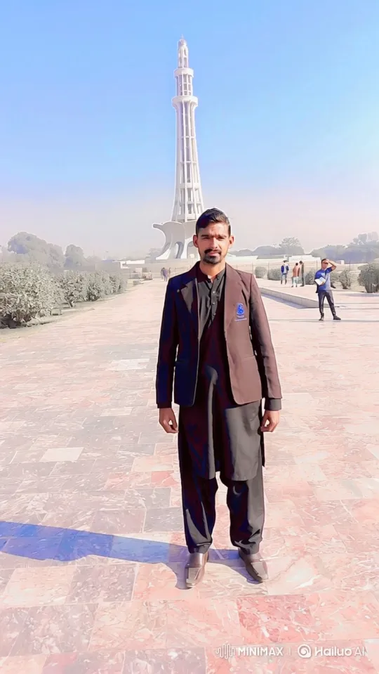 Man Smiles Gently in Plaza with Monument Background – AI Generated Video | Hailuo AI