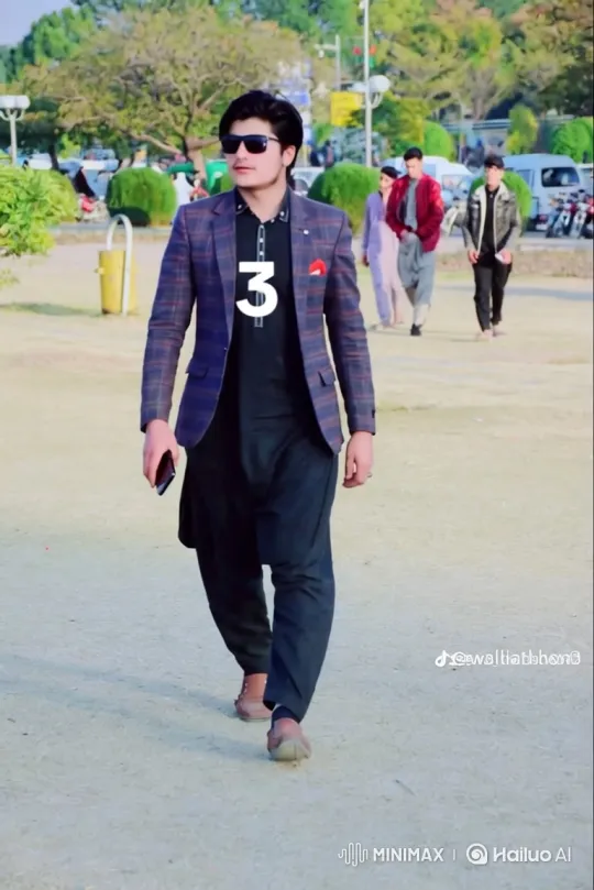 Young Man Walks Confidently in Park with Plaid Blazer – AI Generated Video | Hailuo AI