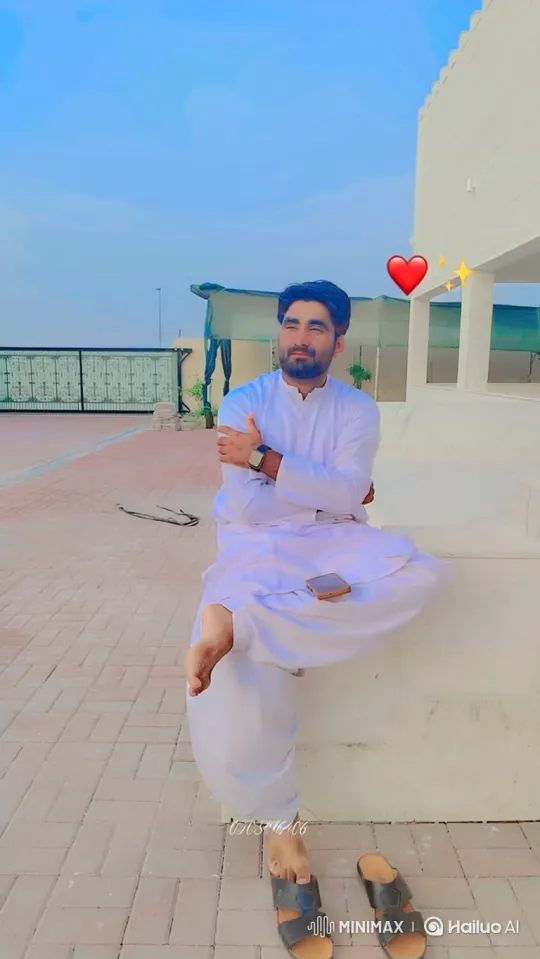 Man in White Clothing Looks at Camera with Smile – AI Generated Video | Hailuo AI