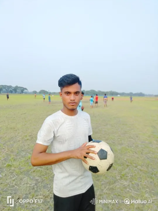 Young Man Holding Soccer Ball on a Grass Field – AI Generated Video | Hailuo AI
