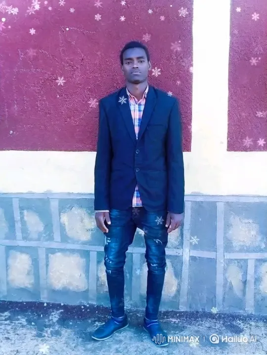 Young Man in Plaid Shirt Stands Still Amidst Animated Snowfall – AI Generated Video | Hailuo AI