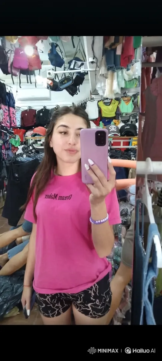 Young Woman Takes Mirror Selfie in Busy Clothing Store – AI Generated Video | Hailuo AI