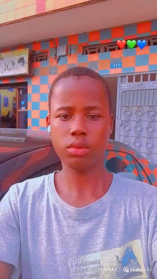 Young Person in Grey T-Shirt Walking Past Colorful Building – AI Generated Video | Hailuo AI