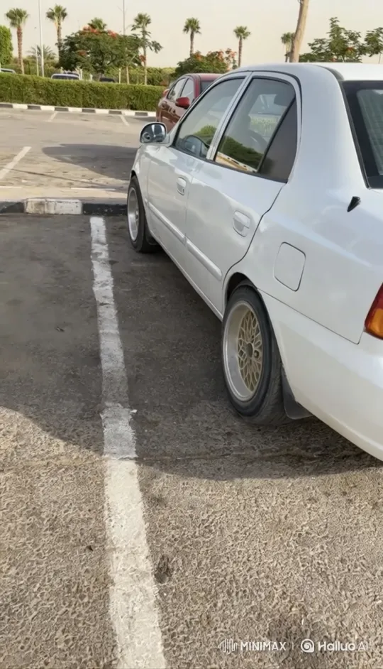 White Sedan with Custom Wheels Lowers on Air Suspension – AI Generated Video | Hailuo AI