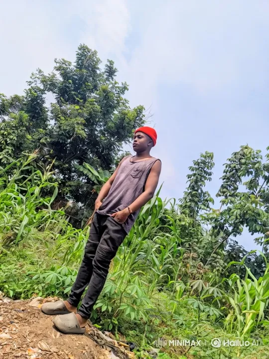 Young Man in Red Beanie Walks Through Lush Greenery – AI Generated Video | Hailuo AI