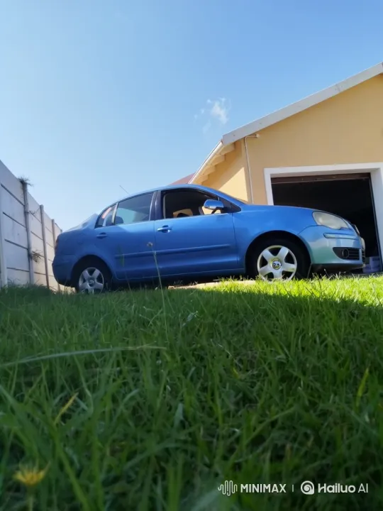 Blue Sedan Demonstrates Air Suspension on Sunny Lawn – AI Generated Video | Hailuo AI