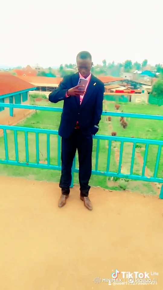 Man in Suit on Platform Observes Town View – AI Generated Video | Hailuo AI
