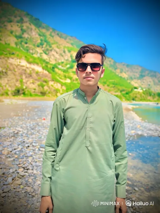 Couple Shares Quiet Moment on Riverbank with Mountains – AI Generated Video | Hailuo AI