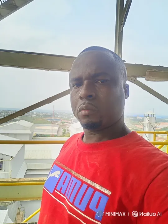Man in Red T-Shirt on Industrial Walkway – AI Generated Video | Hailuo AI