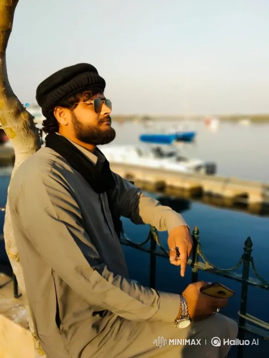 Contemplative Man by Water at Twilight with Smartphone – AI Generated Video | Hailuo AI