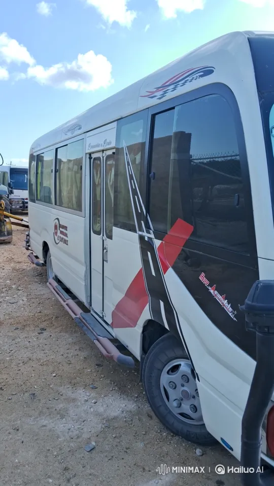 White Minibus Departs from Dusty Lot – AI Generated Video | Hailuo AI