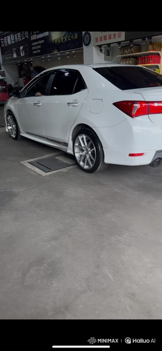 White Sedan Lowering on Air Suspension in Auto Shop – AI Generated Video | Hailuo AI