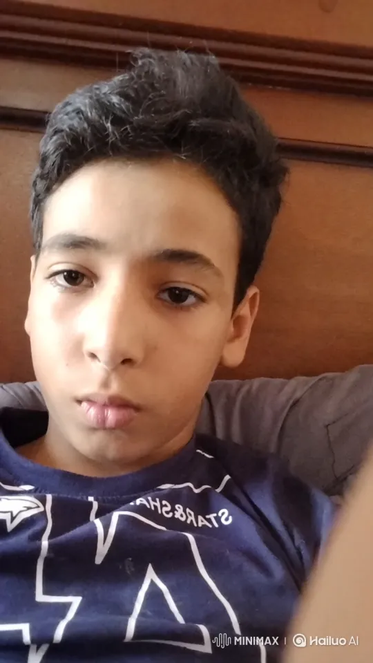 Boy Reflects in Cozy Cafe with Glass of Milk – AI Generated Video | Hailuo AI
