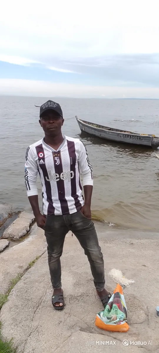 Contemplative Man on Shoreline with 'MV. SAMADORA' Boat – AI Generated Video | Hailuo AI