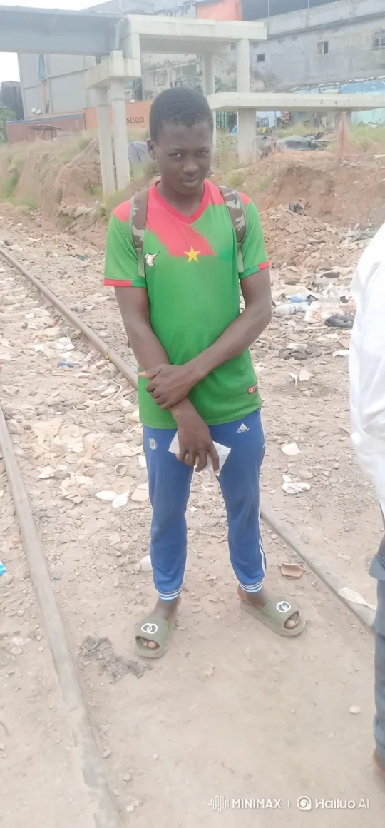 Young Man Walks Along Train Tracks in Industrial Setting – AI Generated Video | Hailuo AI