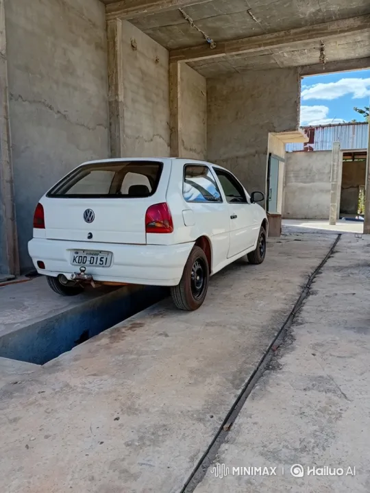 White Hatchback Car Lowering in Industrial Garage – AI Generated Video | Hailuo AI