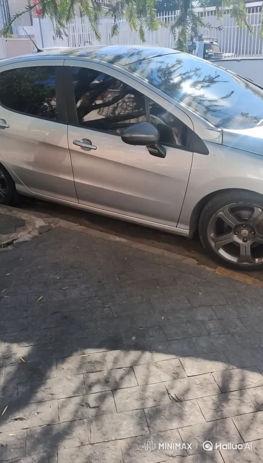Silver Car Parked by White Fence in Sunlit Street – AI Generated Video | Hailuo AI