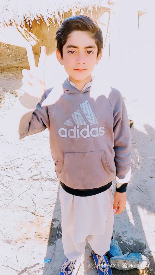 Young Boy in Peace Sign Pose with Gentle Smile – AI Generated Video | Hailuo AI