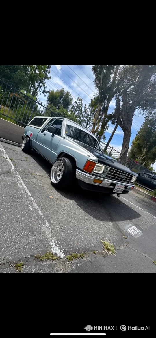 Vintage Pickup Truck with Customizations Lowers on Asphalt Lot – AI Generated Video | Hailuo AI