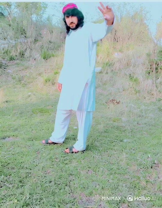 Man in White Clothing Poses in Sunny Grassland – AI Generated Video | Hailuo AI