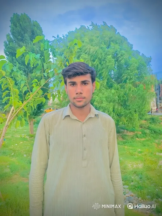 Young Man in Park Amidst Gentle Breeze and Swaying Trees – AI Generated Video | Hailuo AI