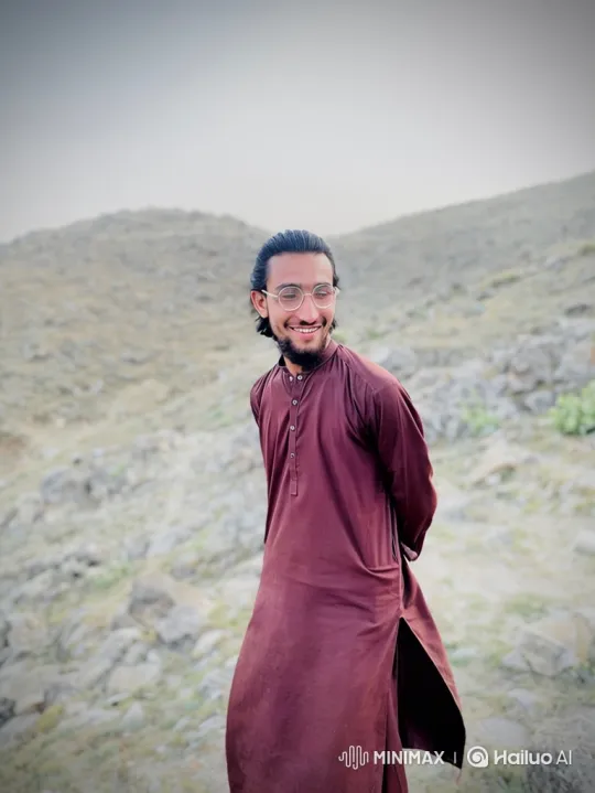 Young Man on Hillside with Gentle Smile and Warm Gaze – AI Generated Video | Hailuo AI