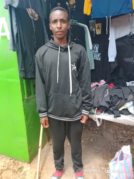 Young Man Stands at Clothing Stall with Dynamic Camera Movement – AI Generated Video | Hailuo AI