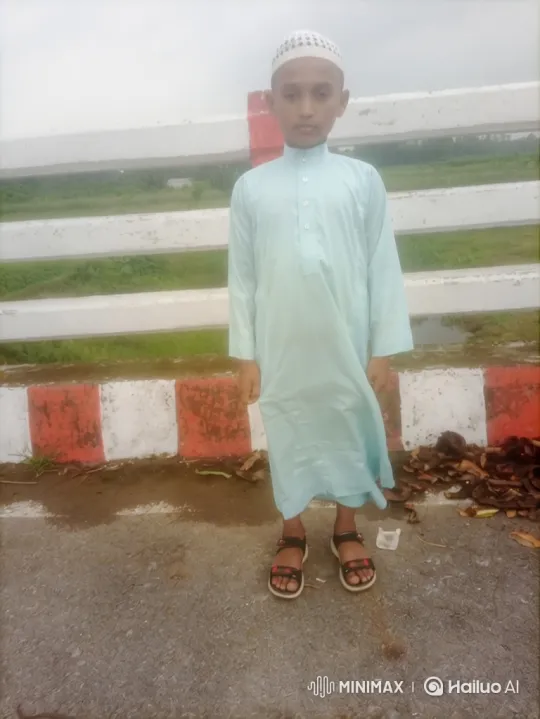 Boy Stands Calmly in Gentle Breeze with Rural Background – AI Generated Video | Hailuo AI